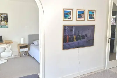 a bedroom with a bed and a wall with a mirror at La Suite de Saint-Jean-Cap-Ferrat, vue mer et accès mer in Saint-Jean-Cap-Ferrat
