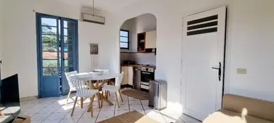 a kitchen with a table and chairs in a room at Bright Appartment perfect location in Saint-Jean-Cap-Ferrat
