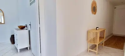 a white refrigerator and a table in a room at Bright Appartment perfect location in Saint-Jean-Cap-Ferrat