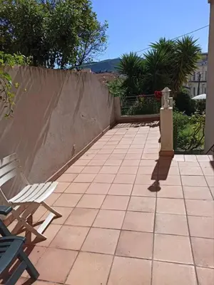 a patio with two chairs and a fence at Villa tres proche du centre ville in Nice