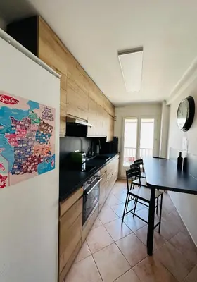 a kitchen with a table and a dining room at The NICE - 3 rooms, 3air cond, 3TV, 3fans, 2 wc, WIfi everywhere 5min aeroport, train, beach, 1min tram, 15 min centre, port, parking possible in Nice