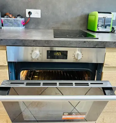 an oven in a kitchen with a counter at The NICE - 3 rooms, 3air cond, 3TV, 3fans, 2 wc, WIfi everywhere 5min aeroport, train, beach, 1min tram, 15 min centre, port, parking possible in Nice