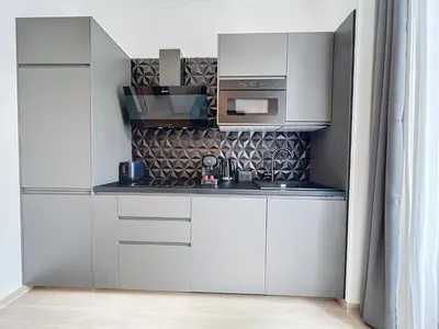 a kitchen with white cabinets and a microwave at Central Beautifull Delille Flat in Nice