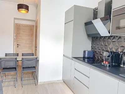 a kitchen with white cabinets and a counter top at Central Beautifull Delille Flat in Nice