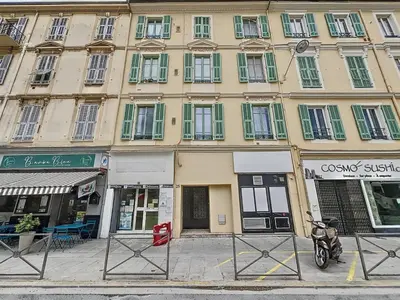 a building with a motorcycle parked in front of it at Central Beautifull Delille Flat in Nice
