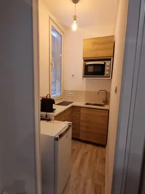 a small kitchen with a refrigerator and a microwave at Appartement Nice Centre Medecin in Nice