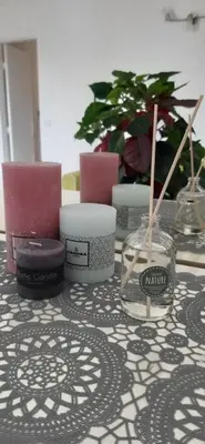 a table topped with candles and vases on a table at Studio cosy à Nice in Nice
