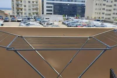 a bench in a parking lot with parked cars at Studio cosy à Nice in Nice