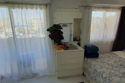 a bedroom with a bed and a dresser with a mirror at Studio cosy à Nice in Nice