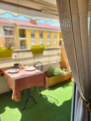a view of a balcony with a table and a building at Une invitation à la détente in Nice
