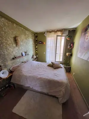a bedroom with a large bed and a window at Une invitation à la détente in Nice