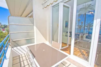 a balcony with a glass table and a view of the ocean at Promenade des Anglais - Sea View 2bdr in Nice