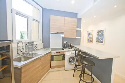 a kitchen with a sink and a washing machine at Promenade des Anglais - Sea View 2bdr in Nice