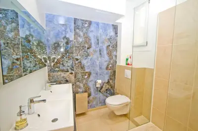 a bathroom with a toilet and a sink at Promenade des Anglais - Sea View 2bdr in Nice