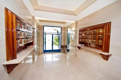 a large room with wooden cabinets and a glass door at Promenade des Anglais - Sea View 2bdr in Nice