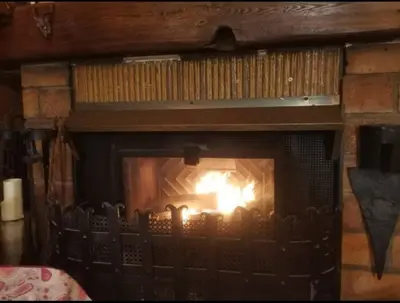 a fireplace with a fire inside of it at Maison traditionnelle sur les collines Niçoises in Nice
