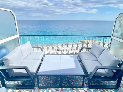 a balcony with two chairs and a table and the ocean at SEA FRONT View Top Roof Flat in Nice