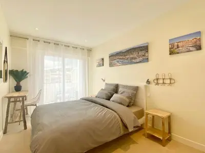 a bedroom with a bed and a table and a window at SEA FRONT View Top Roof Flat in Nice