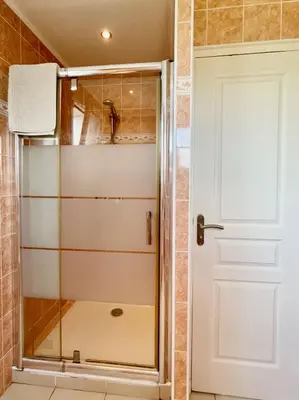 a shower with a glass door in a bathroom at Villa SYAGRUS - Easy Home Booking in Nice