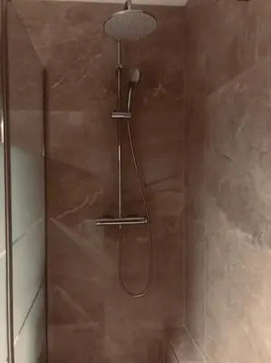 a shower with a shower head in a bathroom at Studio refait neuf Centre-ville in Nice