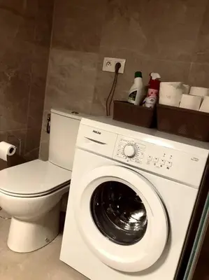 a bathroom with a washing machine and a toilet at Studio refait neuf Centre-ville in Nice