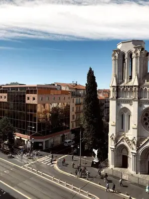 a city with a church and a street with people walking at Studio refait neuf Centre-ville in Nice