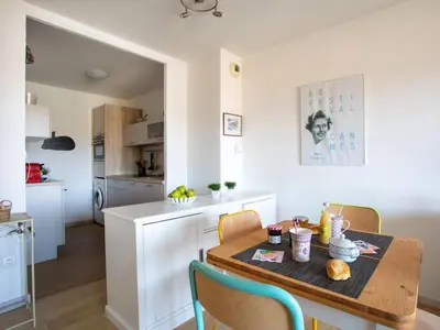 a kitchen and dining room with a table and chairs at Apartment Le Lagon Bleu by Interhome in Cagnes-sur-Mer