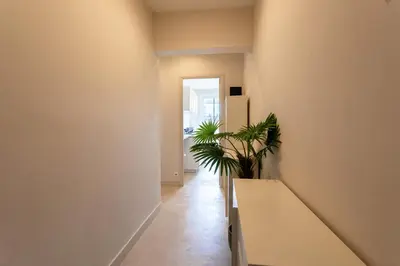 a hallway with a bench and a plant at URBAN AP4346 By Riviera Holiday Homes in Nice