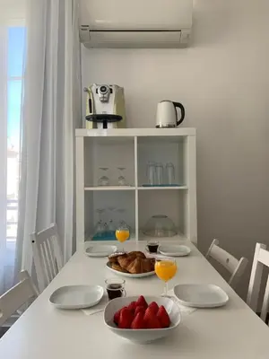 a table with plates of food and glasses of orange juice at Central Rossini Flat with Balcony in Nice