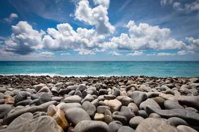 a large group of rocks on a beach at Central Rossini Flat with Balcony in Nice