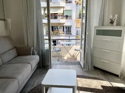 a living room with a couch and a table at Central Rossini Flat with Balcony in Nice