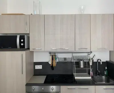 a kitchen with a sink and a stove top oven at Central Rossini Flat with Balcony in Nice