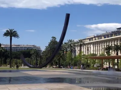 a large sculpture in a park with a building at Studio Climatisé dans villa bourgeoise in Nice