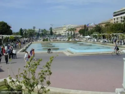a group of people standing around a large fountain at Studio Climatisé dans villa bourgeoise in Nice