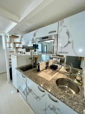 a kitchen counter with a sink and a mirror at Duplex cosy - hyper centre - Proche mer et Promenade in Nice