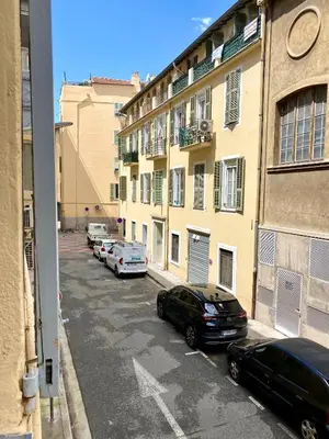 a parking lot with cars parked in front of buildings at Duplex cosy - hyper centre - Proche mer et Promenade in Nice