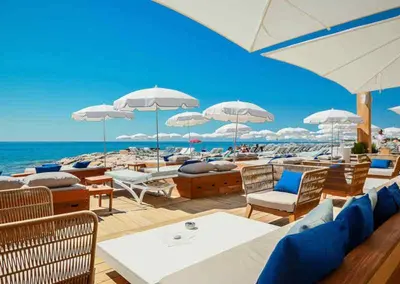 a group of chairs and umbrellas on a beach at Duplex cosy - hyper centre - Proche mer et Promenade in Nice