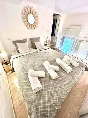 a bedroom with a large bed with two white towels on it at Duplex cosy - hyper centre - Proche mer et Promenade in Nice
