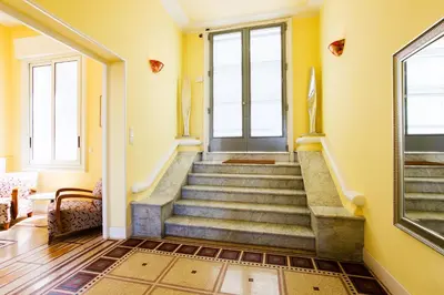 a staircase in a home with yellow walls at LE CAP DE NICE VI4150 by RIVIERA HOLIDAY HOMES in Nice