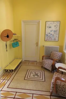 a living room with a door and a chair and a rug at LE CAP DE NICE VI4150 by RIVIERA HOLIDAY HOMES in Nice