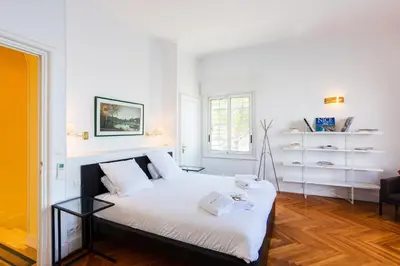 a white bedroom with a bed with white sheets at LE CAP DE NICE VI4150 by RIVIERA HOLIDAY HOMES in Nice