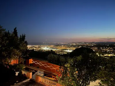 a view of a city at night at Chambre d'hôtes A l'ancre marine de la Villa Rose in Nice