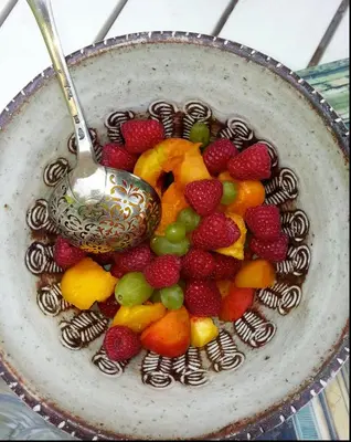 a bowl of fruit with a spoon in it at Chambre d'hôtes A l'ancre marine de la Villa Rose in Nice