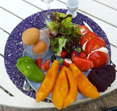a plate of fruit and vegetables with an egg on it at Chambre d'hôtes A l'ancre marine de la Villa Rose in Nice