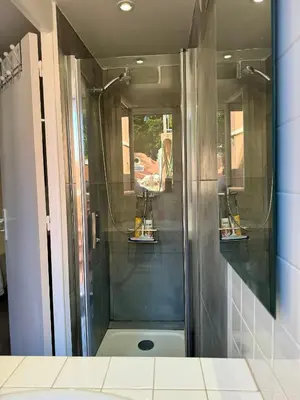 a shower with a glass door in a bathroom at Chambre d'hôtes A l'ancre marine de la Villa Rose in Nice