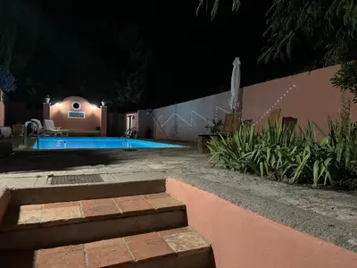 a swimming pool in a yard at night at Chambre d'hôtes A l'ancre marine de la Villa Rose in Nice