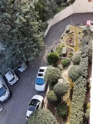 a group of cars parked in a parking lot at Grand appartement proche Promenade in Nice