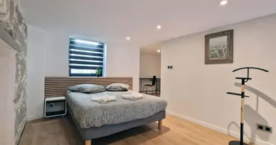 a bedroom with a bed with two pillows and a window at Très joli loft au cœur de Nice in Nice