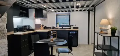 a kitchen with a table and chairs in a room at Très joli loft au cœur de Nice in Nice
