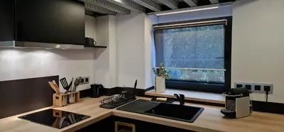 a kitchen with a counter with a sink and a window at Très joli loft au cœur de Nice in Nice